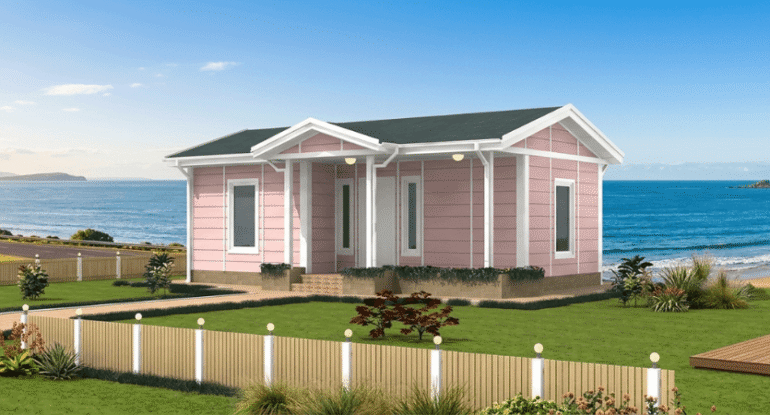 Deniz manzaralı bir araziye kurulmuş, modern mimariye sahip, pembe dış cephe panelleriyle dikkat çeken Alyans Prefabrik tek katlı modüler ev.